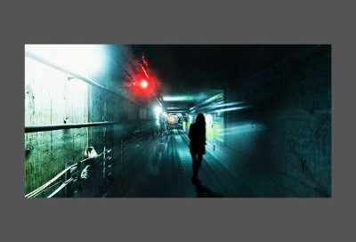 Image shows the silhouette of a woman in an underground rail tunnel with pipework and lights along the wall beside her