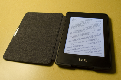 An open Kindle eReader on a yellow background